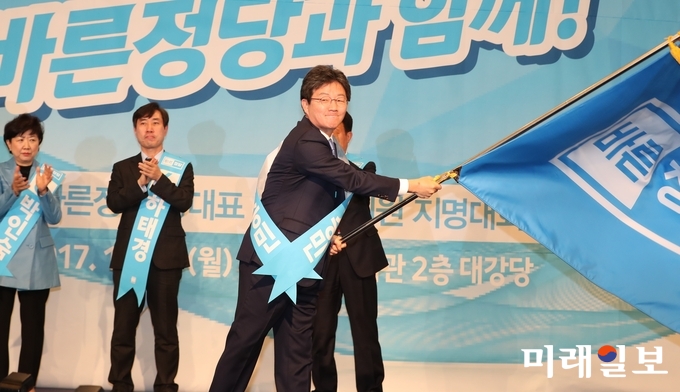 13일 오전 국회 헌정기념관에서 열린 바른정당 당 대표 및 최고위원 지명대회에서 새 대표로 선출된 유승민 후보가 당기를 흔들고 있다./사진=김정현 기자
