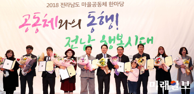 김영록 전라남도지사가 22일 오후 영암군 삼호읍 호텔현대에서 열린 2018 전라남도 마을공동체 한마당 행사에서 마을공동체 발전에 이바지한 유공자에 대한 표창장을 수여한 뒤 기념촬영을 하고 있다. 마을공동체 한마당은 그동안 마을공동체 활동의 성과를 주민들과 소통ㆍ공유하는 뜻깊은 자리이다. / 사진=전남도 제공