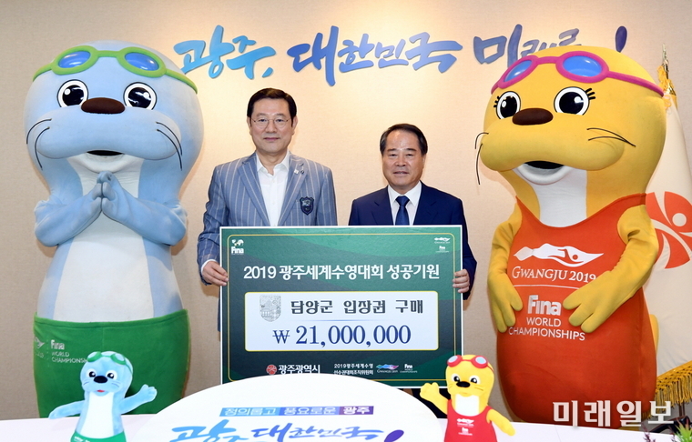 이용섭 광주광역시장이 7일 오전 시청 3층 접견실에서 열린 ‘수영대회 입장권 구매증서 전달식’에서 최형식 담양군수로부터 입장권 구매증서를 전달 받고 기념촬영을 하고 있다. / 사진=광주시 제공