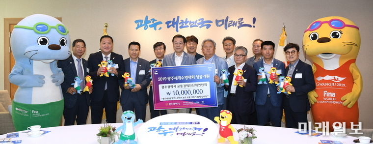 이용섭 광주광역시장이 2일 오전 시청 3층 접견실에서 열린 ‘수영대회 입장권 구매증서 전달식’에서 조정래 광주광역시 교통경제인단체협의회 회장으로부터 입장권 구매증서를 전달 받고 기념촬영을 하고 있다./사진=광주시 제공